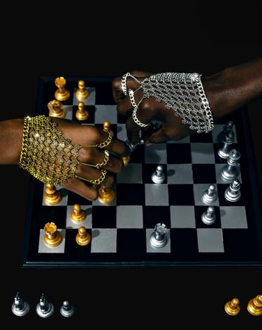 a person's hand wearing a chainmail while playong chess