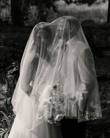 bride and groom under a veil