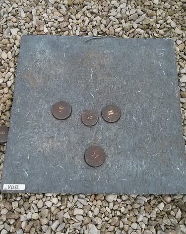 a stone slab with coins and coins on it