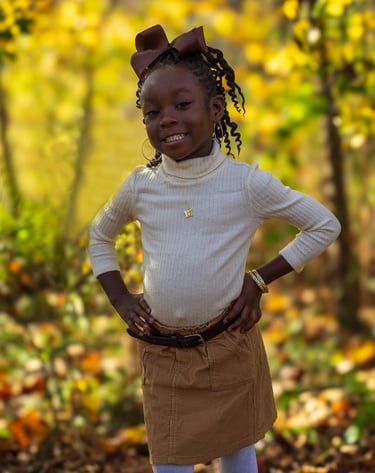 A young girl pictured in a fall setting