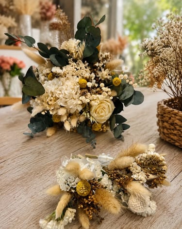 Rustic dried flower wedding bouquet and matching boutonnieres with eucalyptus and bunny tails on a wooden table.