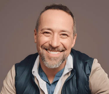 Young man smiling with brown hair and blue jacket sharing review for Breathe Thru Recovery