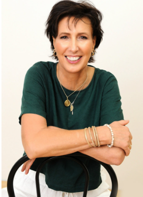 a woman in a green shirt and white pants