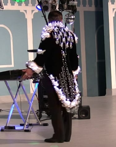 'The Chandelier Jacket' from the back during a performance by 'HencetheOutfit'