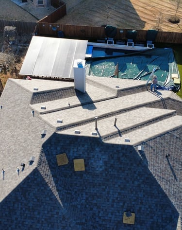 overhead shot of a roof replacement with great care being taken for customers property, pool covered