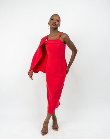 a woman in a red dress and a red capelet