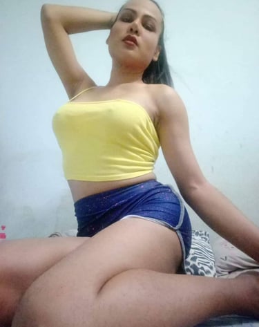 ladyboy therapist wearing short yellow top and blue shorts