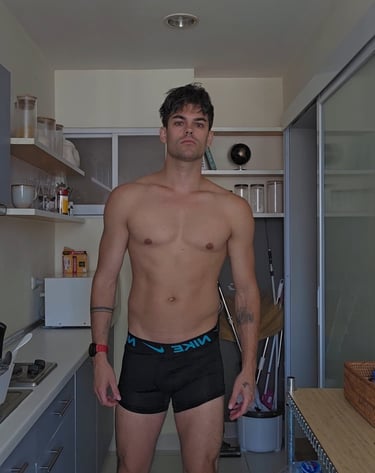 a man wearing black boxer shorts taken in a kitchen