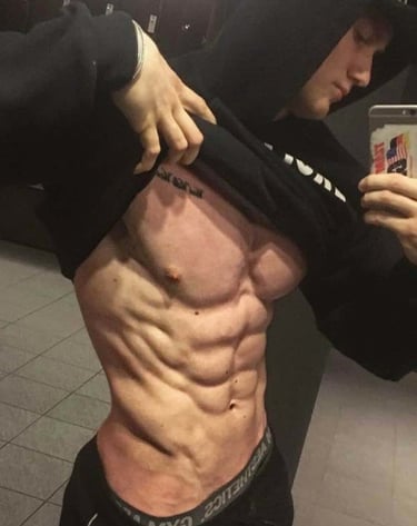 a man revealing his muscular abdomen