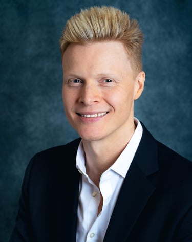 a man in a suit and white shirt