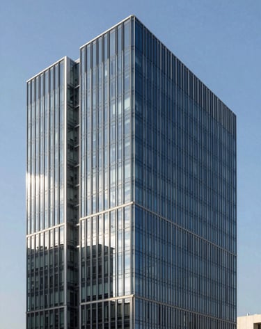 Architectural shot of a modern Brazilian business center with a minimalist design. The building features steel blue glass and clean geometric lines against a clear sky, conveying a refined and contemporary aesthetic.