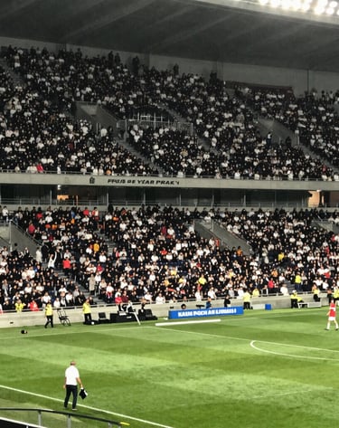 Streetwear look featuring a bold soccer jersey paired with sneakers and urban backdrop.