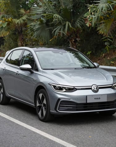 Smiling customer shaking hands with a sales representative beside a white SUV.