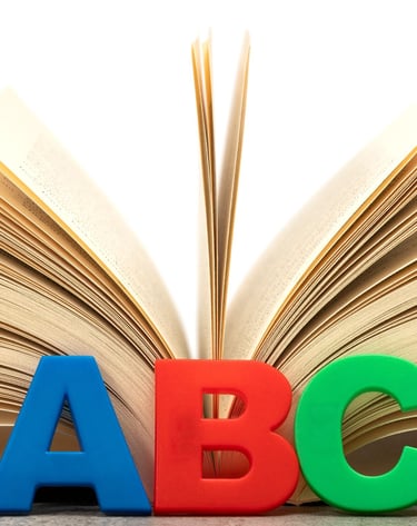 Open book with alphabet letters.