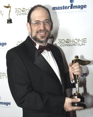 Ken Schafer Receiving Lumiere Statuette