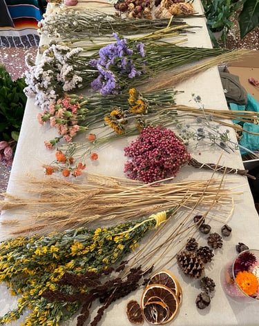 a table with a bunch of dried flowers