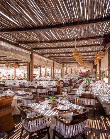 a restaurant with tables and chairs and a wooden table