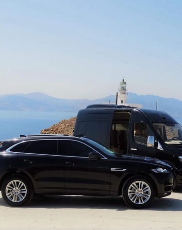 a van parked on a hill with a lighthouse in the background