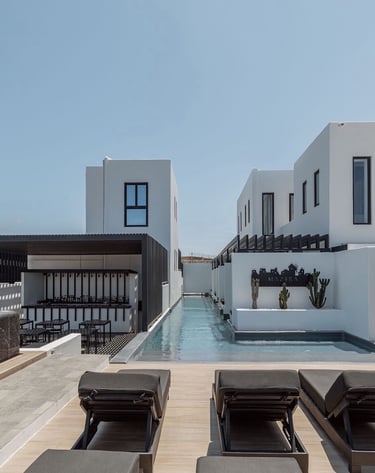 a pool with lounge chairs and a pool