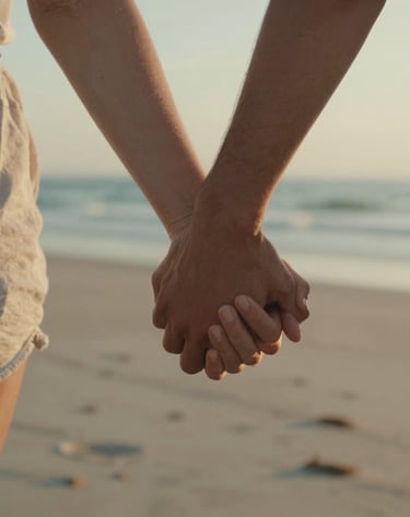 A cinematic close-up of two hands held tight during a walk along a North American beach at golden hour, sun-drenched skin, authentic and emotional mood, warm cinematic grading.