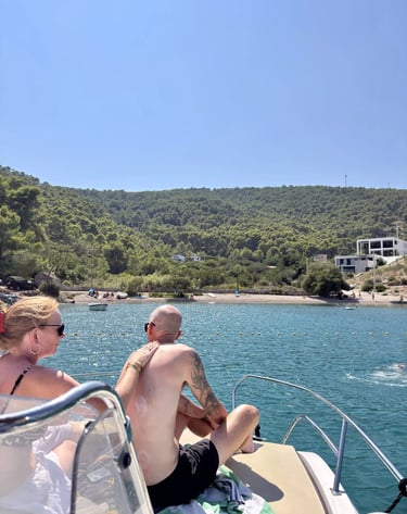 Couple applying sun protection on a boat at Krusica Bay on Solta during a private boat tour from Split