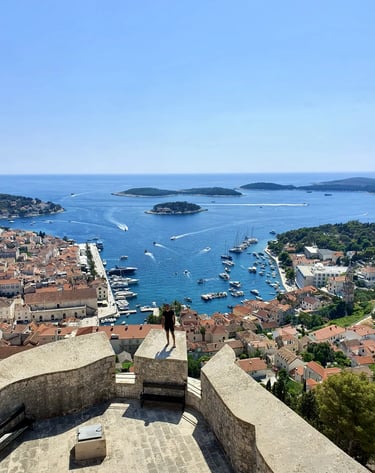 Man at Fortica Fortress in Hvar overlooking Hvar town and Pakleni Islands during private boat tour from Split.