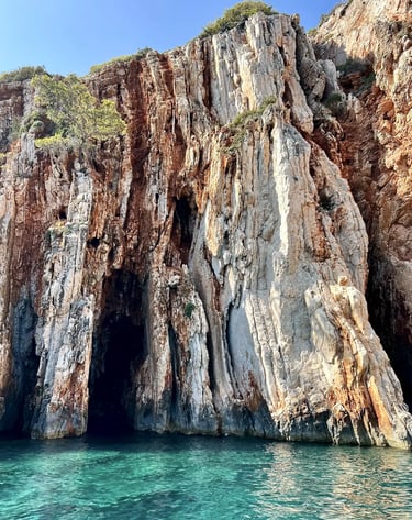 Sea level view of Red Rocks cliffs on the island of Hvar, taken during a private boat tour from Split