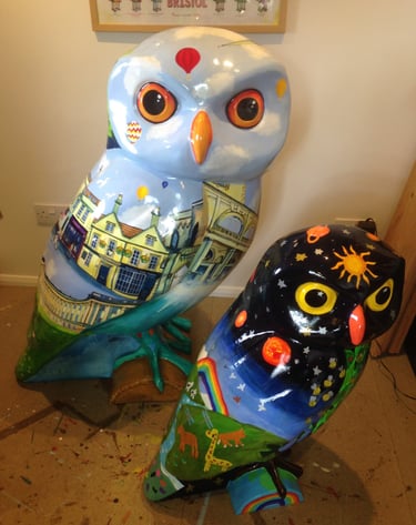 Two painted owls for Owls of Bath Sculpture trail, by Laura Fearn. Front