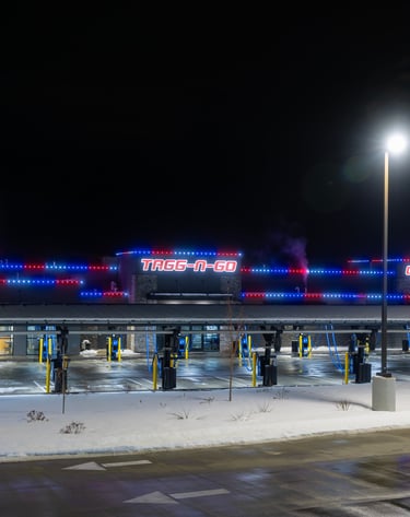 Red and blue lights shining at night that are installed on a car wash