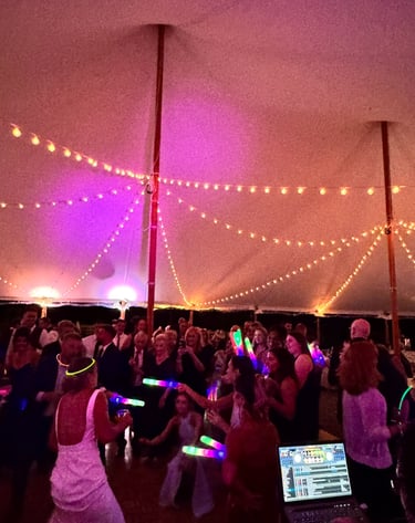 a group of people dancing in a tent