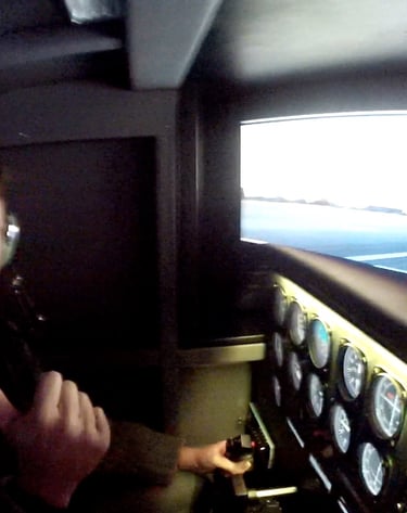 a man in a pilot's seat in a flight simulator