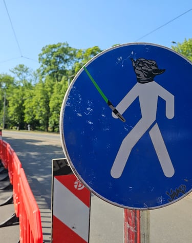 a street sign with a star wars lightsabed sticker on it