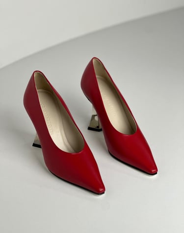 Judy Mazzotti pair of red shoes with a white background