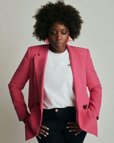 Black woman in a pink jacket and jeans