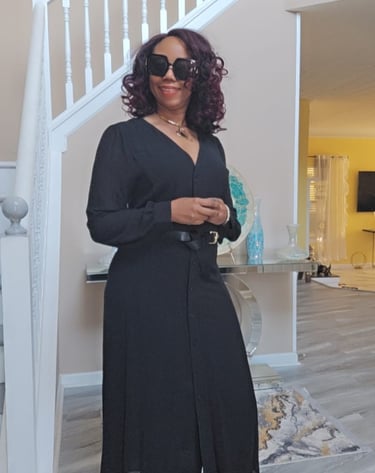 a woman in a black dress and red shoes
