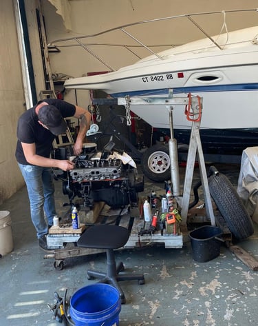 Replacing spark plugs on a Mercury outboard engine near Welland.