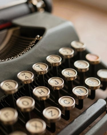 A close-up photograph of a vintage typewriter's metal keys. The focus is sharp on the letters, with a soft blur in the background. The lighting suggests late afternoon in a study, using muted espresso and antique gold tones.