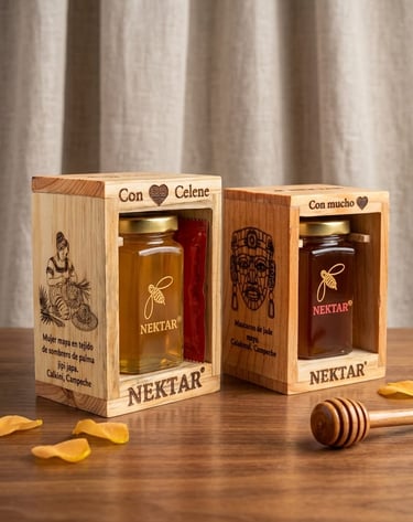 Two jars of Nektar natural honey in decorative wooden gift boxes with a honey dipper on a table.