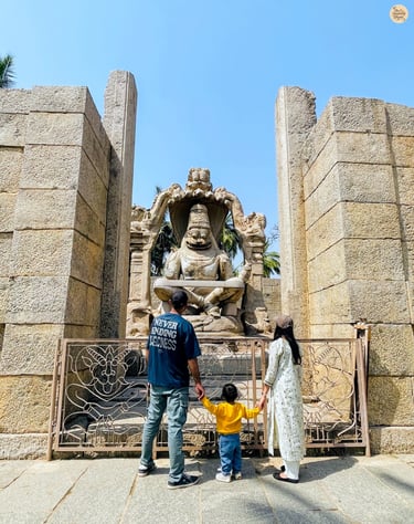 With Lakshmi Narasimha—family moments beside divine strength in stone.