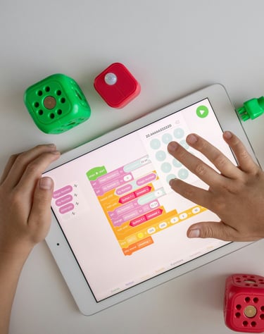 a child's hands on a tablet with dice