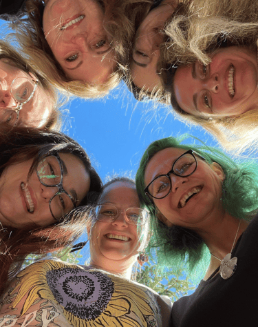 a group of women standing in a circle