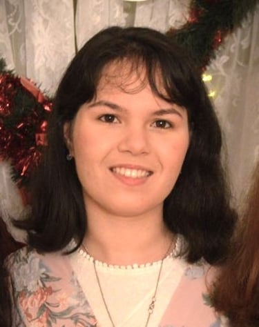 a woman in a floral dress smiling for the camera