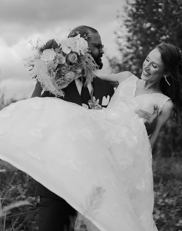 a bride and groom are holding their wedding dress