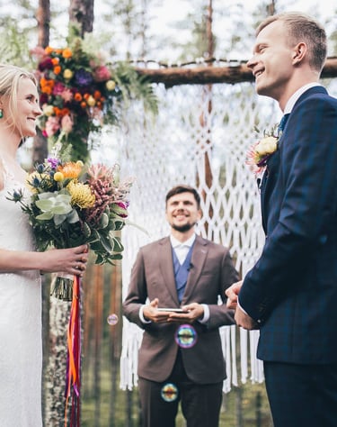 a bride and groom are getting married in a forest