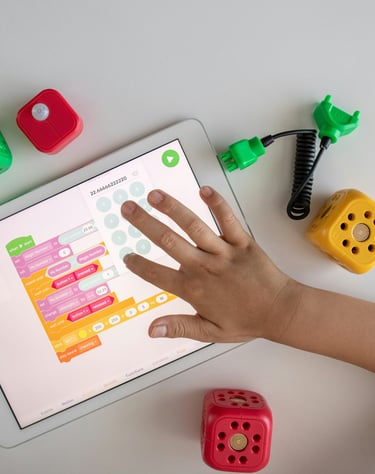 a child's hands on a tablet with dice