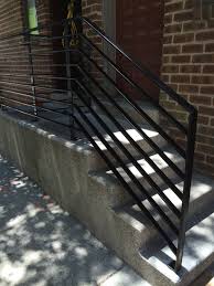 a white outdoor staircase with a handrail