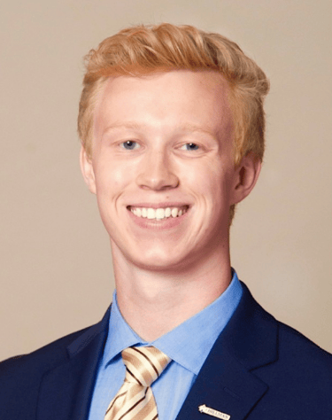 a man in a suit and tie smiling - Branden Denchfield