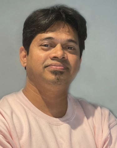 a man with a pink shirt and a cell phone - Radyan Raheev