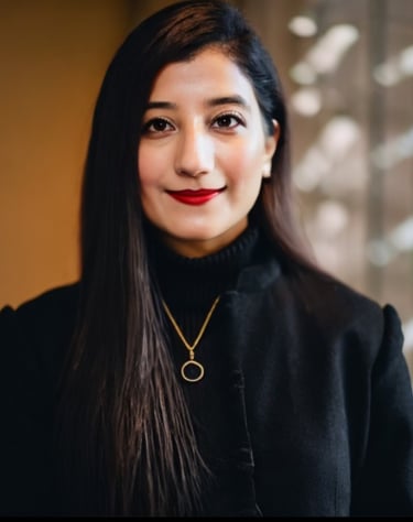 a woman with long hair and a necklace with a gold necklace - Maimoona Iqbal