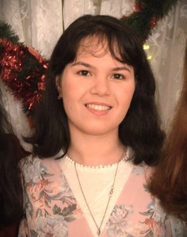 a woman in a floral dress smiling for the camera